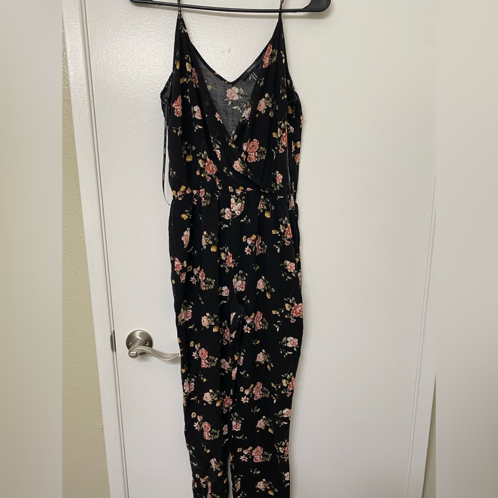 Black Forever 21 romper with pink rose pattern in size medium.